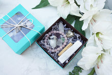 Load image into Gallery: Contempo Crystals - Teal lid and open Crystal Gift Set with Rose Quartz Bracelet, Selenite, Fluorite Octahedrons, Moonstone Tumble, Pyritte Chunk, Quartz Point and a Palo Santo Stick - Image 5
