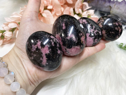 Gorgeous Madagascar Rhodonite pebbles in hand