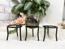 Load image into Gallery: Contempo Crystals - These simple black metal sphere stands are perfect for holding your favorite spheres or eggs.  - Image 4