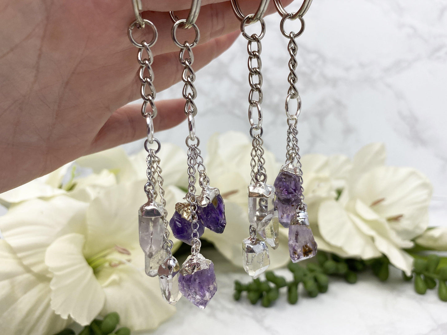 Silver plated clear quartz and amethyst crystal point keychains.