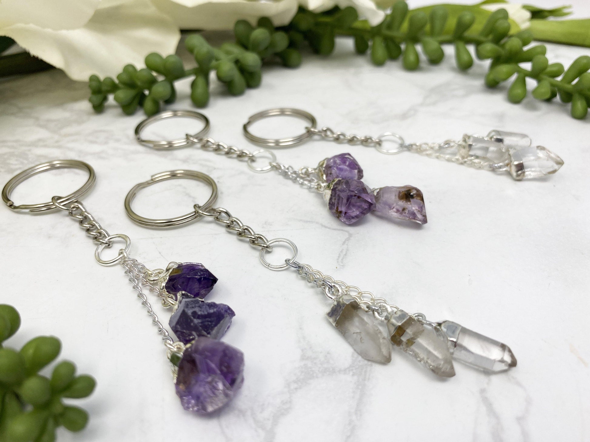 Clear quartz and amethyst crystal keychains.