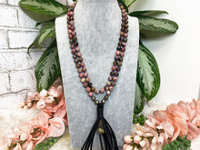 Load image into Gallery: Contempo Crystals - Pink-Rhodonite-Gold-Pyrite-Black-Vegan-Leather-Tassel-Mala-Necklace - Image 1