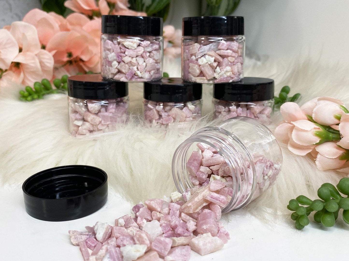 Raw pink tourmaline crystal chips in jar