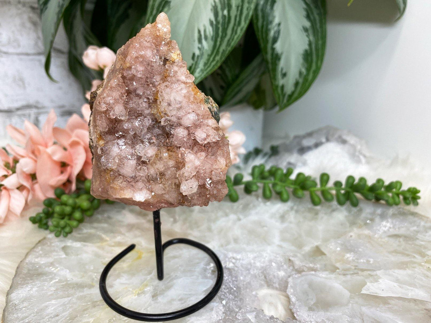 Rose amethyst crystal geode on stand