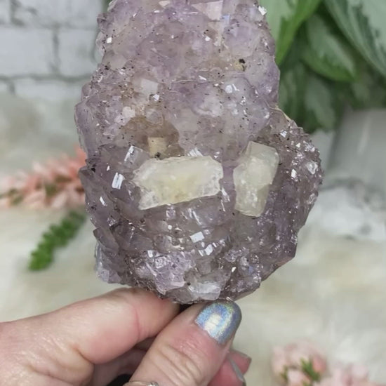 Quality Brazilian amethyst crystal that has actually grown over calcite.  The face also has pieces of calcite showing.  This piece is on a black metal stand (cannot come off).  Very unique piece due to the amethyst growing on the calcite!