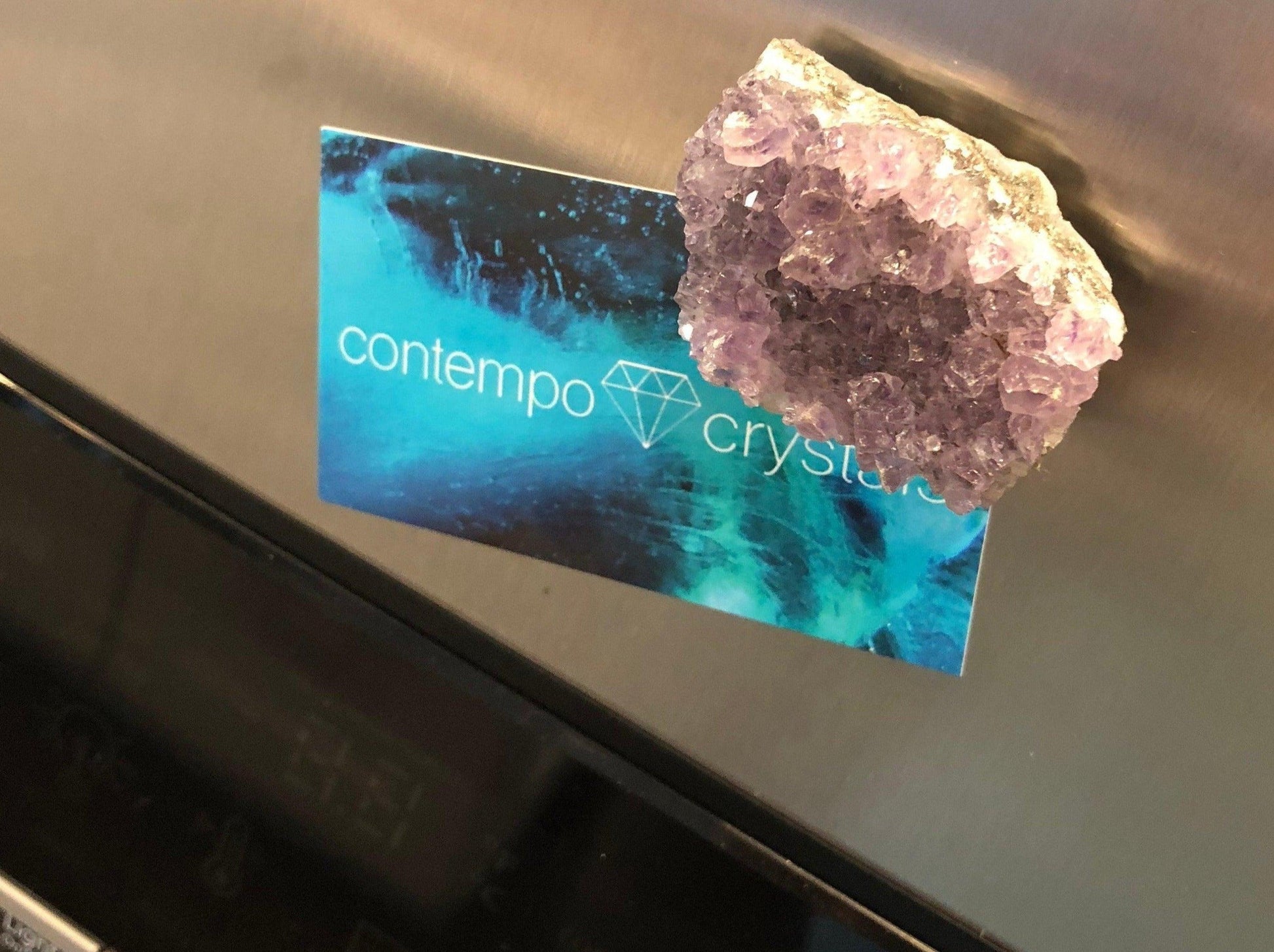 Amethyst Crystal Magnets with beautiful purple front and natural back. Helping to promote a restful night of sleep. Showing magnet on metal surface